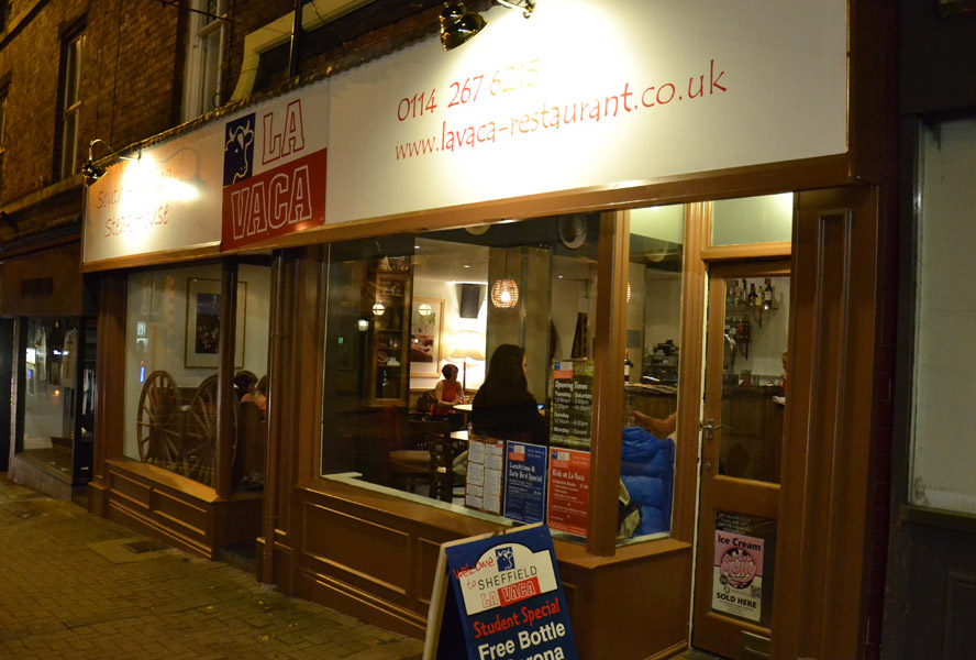 La Vaca's lit shopfront on Glossop Road at night